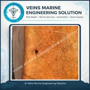 Collision-induced hole at MV Vosco Prosper bulbous bow showing active leakage area before temporary repair and sealing work